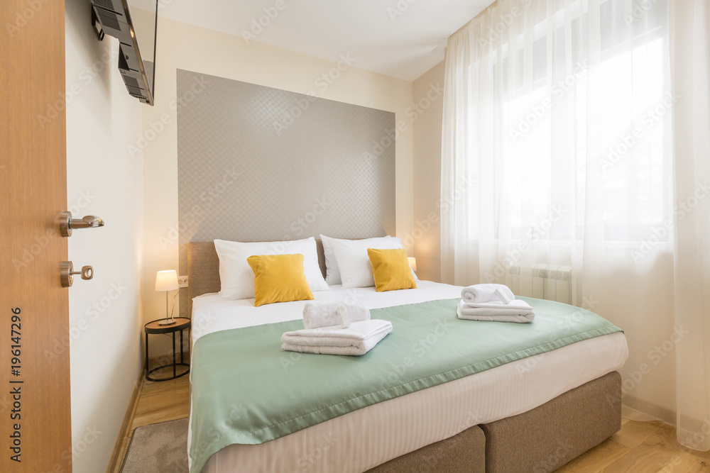 Naklejka premium Interior of a hotel bedroom with double bed