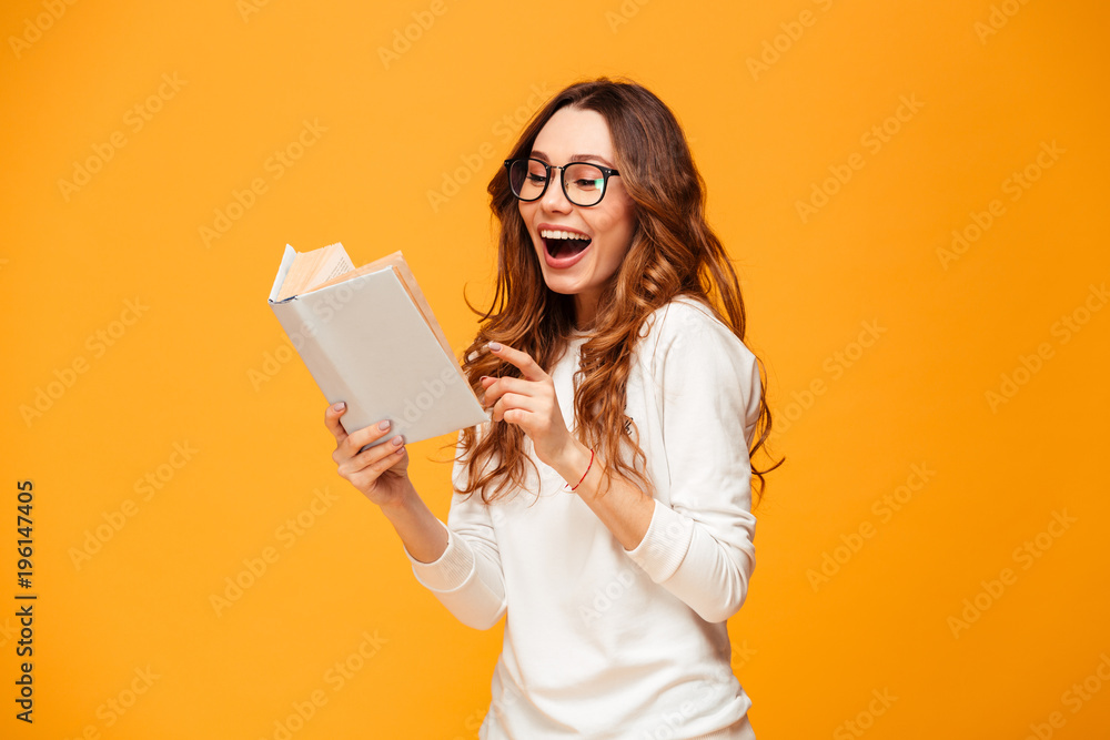 Cheerful brunette woman in sweater and eyeglasses reading book Cheerful brunette woman in sweater and eyeglasses reading book
