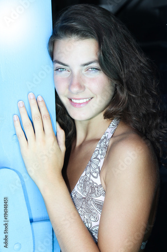 beautiful woman outside the hand on the blue wooden door