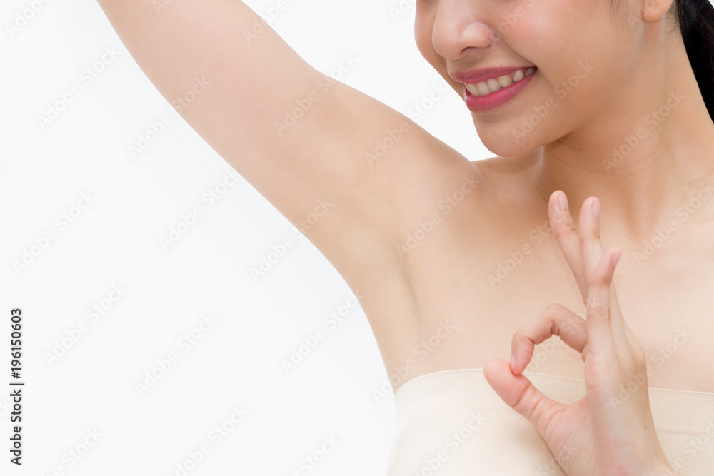 Young Asian woman lifting hands up to show off clean and hygienic armpits or underarms and giving okay sign - smooth armpit cleanliness and protection concept. Young Asian woman lifting hands up to show off clean and hygienic armpits or underarms and giving okay sign - smooth armpit cleanliness and protection concept.