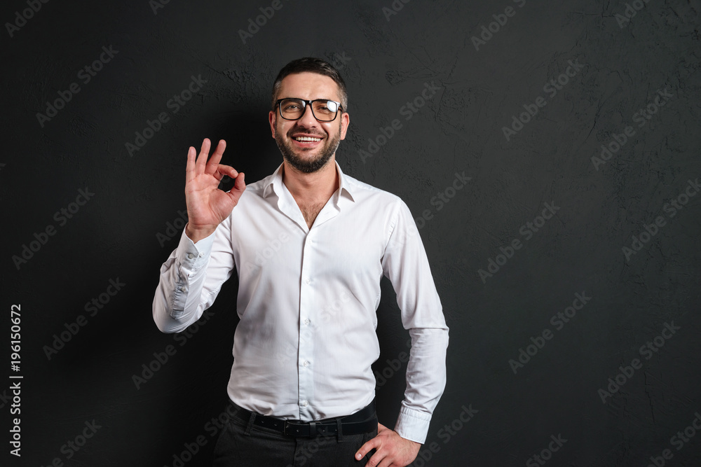 Happy businessman showing okay gesture. Happy businessman showing okay gesture.