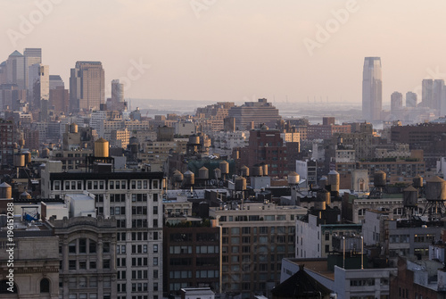 Rooftop view/New York seen from a rooftop at sunset with the old and new quarters and the landmark water tanks.