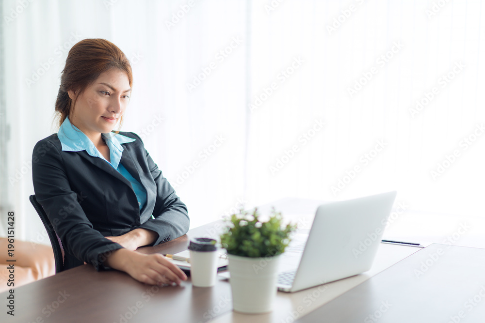 Asian woman manager putting her ideas and writing business plan at workplace Asian woman manager putting her ideas and writing business plan at workplace