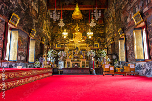 Inside the temple of Wat Arun Ratchawararam showing the image of golden Buddha © phichak