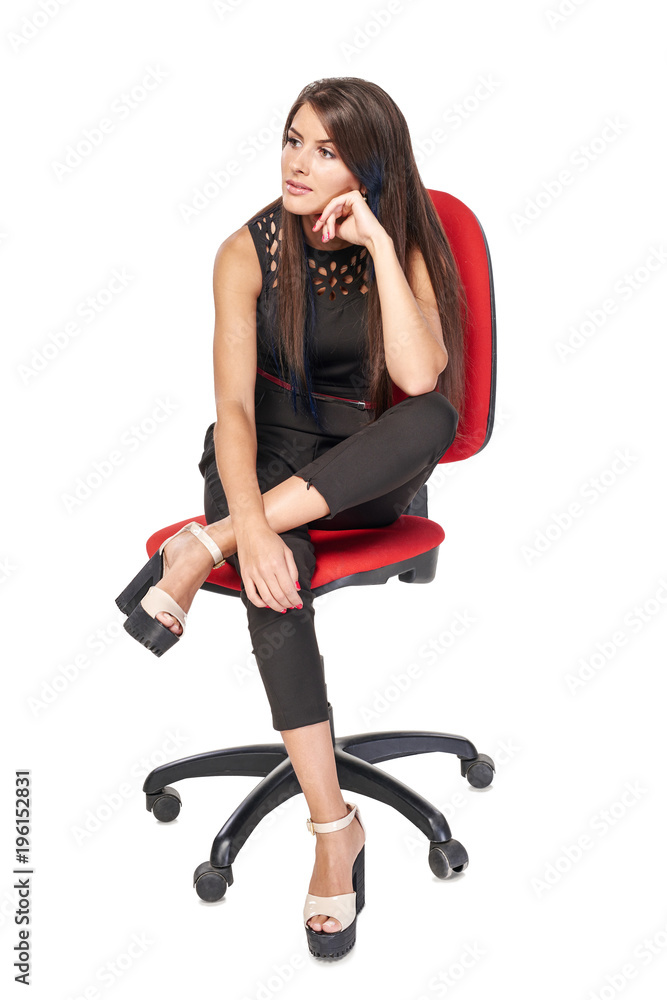 Thinking woman in black sitting on office chair leaning on elbow looking to the side, full length portrait Thinking woman in black sitting on office chair leaning on elbow looking to the side, full length portrait