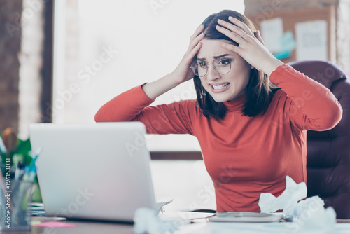Modern technology financier economist people person concept. Hulf-turned portrait of sad unhappy upset disappointed journalist economist business lady holding head on hands looking at screen monitor