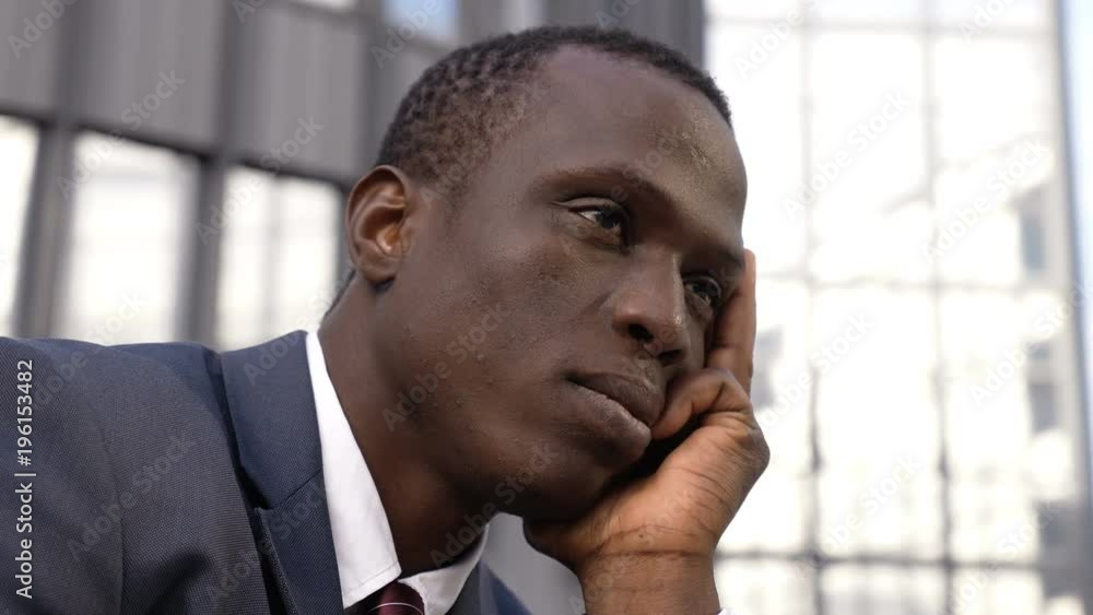 worried and pensive young black american business man in the city worried and pensive young black american business man in the city