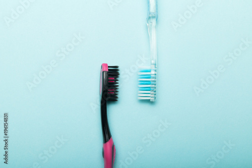 Two toothbrushes on a blue background for hygiene of the oral cavity.
