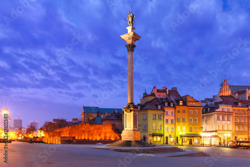 Castle Square with Royal Castle, colorful houses and Sigismund Column called Kolumna Zygmunta in Old town during morning blue hour, Warsaw, Poland.