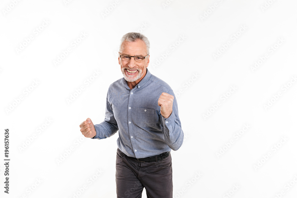 Happy mature man making winner gesture isolated Happy mature man making winner gesture isolated