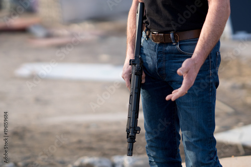 Cropped image of a man holding a rifle