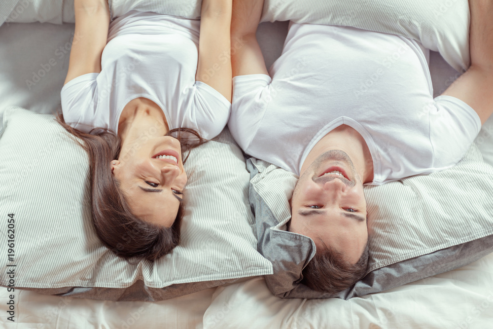 Fototapeta premium beautiful couple lying together on the bed