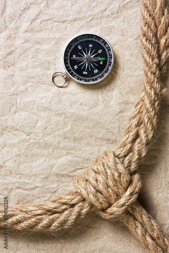 compass, old paper and rope