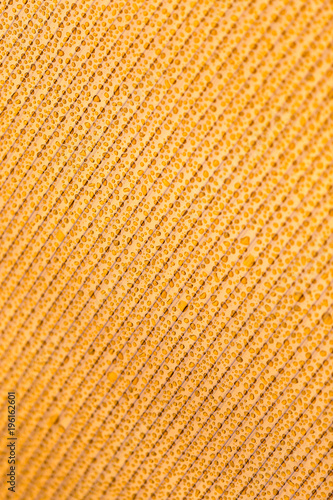 Drops of water on orange plastic as background