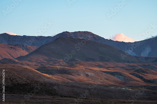 Beautiful colorful grassland mountain with blue sky at sunset.