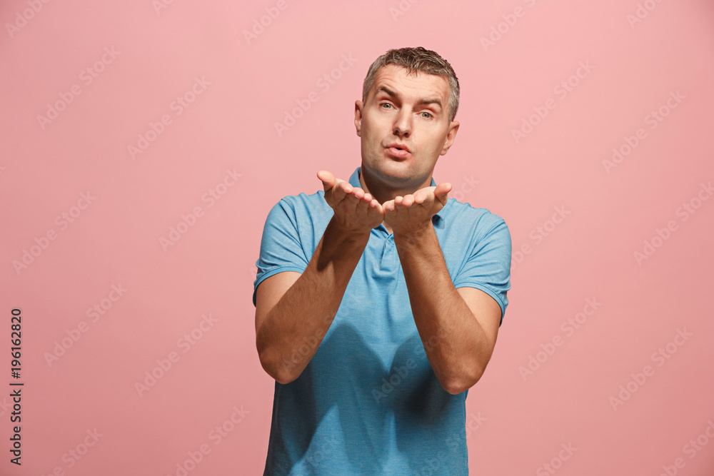 Portrait of attractive man with kiss isolated over pink background Portrait of attractive man with kiss isolated over pink background