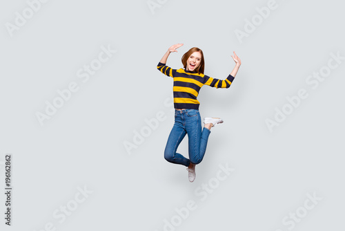 Lifestyle leisure astonished shock unbelievable incredible careless holidays concept. Full-length full-size portrait of cute cheerful wondered pretty mad manager jumping up isolated gray background