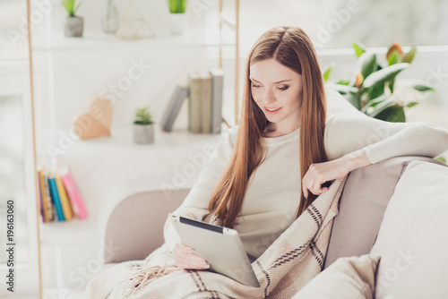 People vacation weekend holiday fashion beauty tenderness concept. Beautiful charming relaxed cute lovely gentle woman doing shopping watching videos reading book using digital tablet sitting on chair