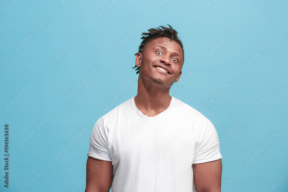 The squint eyed afro-american man with weird expression isolated on blue The squint eyed afro-american man with weird expression isolated on blue