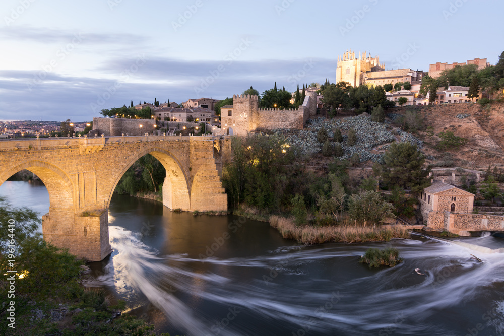 Evening view of Toledo old town, de Alcantara bridge and Tagus river