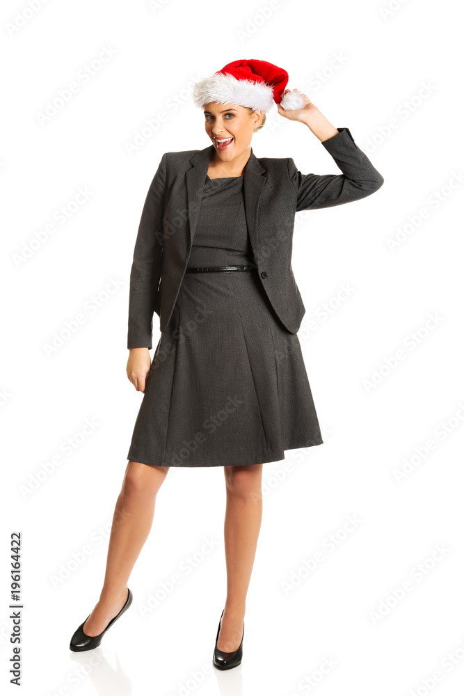 Happy businesswoman wearing christmas hat Happy businesswoman wearing christmas hat