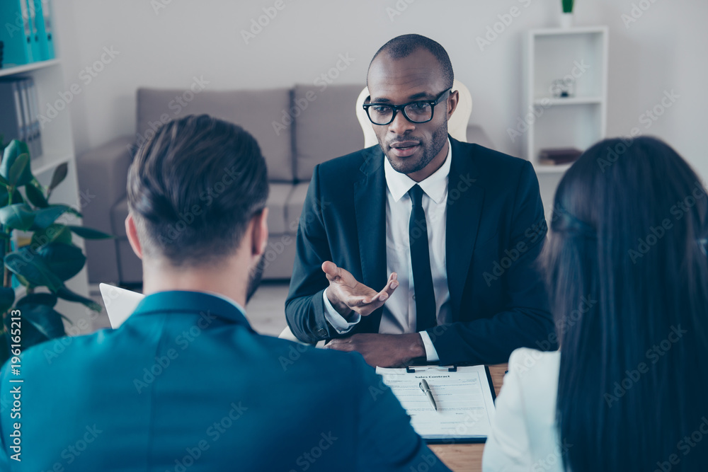Obraz premium Black, professional, afroamerican, serious lawyer in classic suit making consultation to bisnesspeople who want to make a deal about their business, together sitting in work place, station