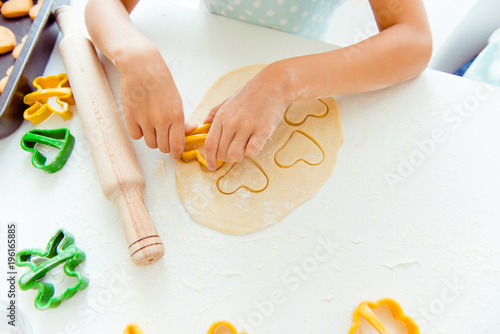 Mother holiday friendship together support international concept. Above top view cropped close up photo of small cute lovely hands making cookies holding form cutting figures