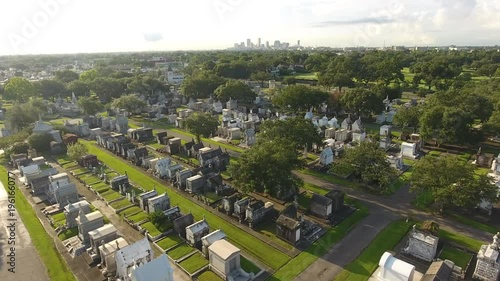 Towards Distant Downtown Beyond Large Lush New Orleans Cemetery photo