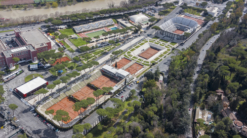 Photography Aerial view of the red clay tennis courts of the Foro Italico, a sports facility in Rome hosting the Italian international tournament
