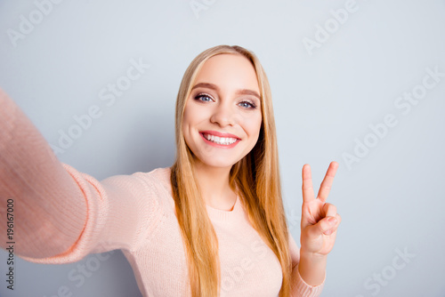 Connection casual roaming glamour style toothy people funtime person concept. Close up portrait of cute cheerful excited sweet lovely joyful girl taking selfie with v-sign isolated on gray background