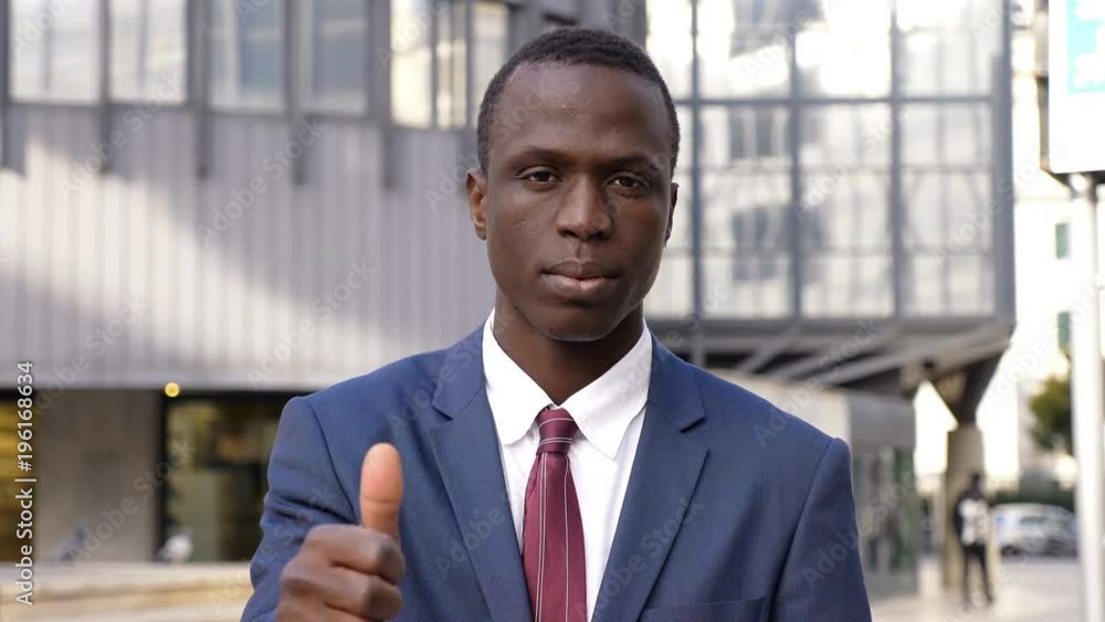 confident serious black african business man making thumb upman confident serious black african business man making thumb upman