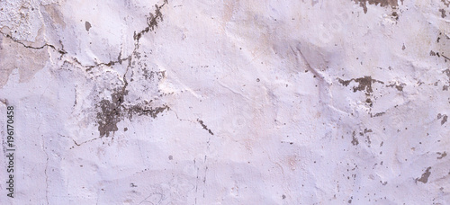 Old cracked rought white plaster wall texture banner background