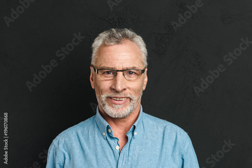 Obraz na plátně Horizontal photo of mature unshaved man 60s with grey hair wearing eyeglasses sm
