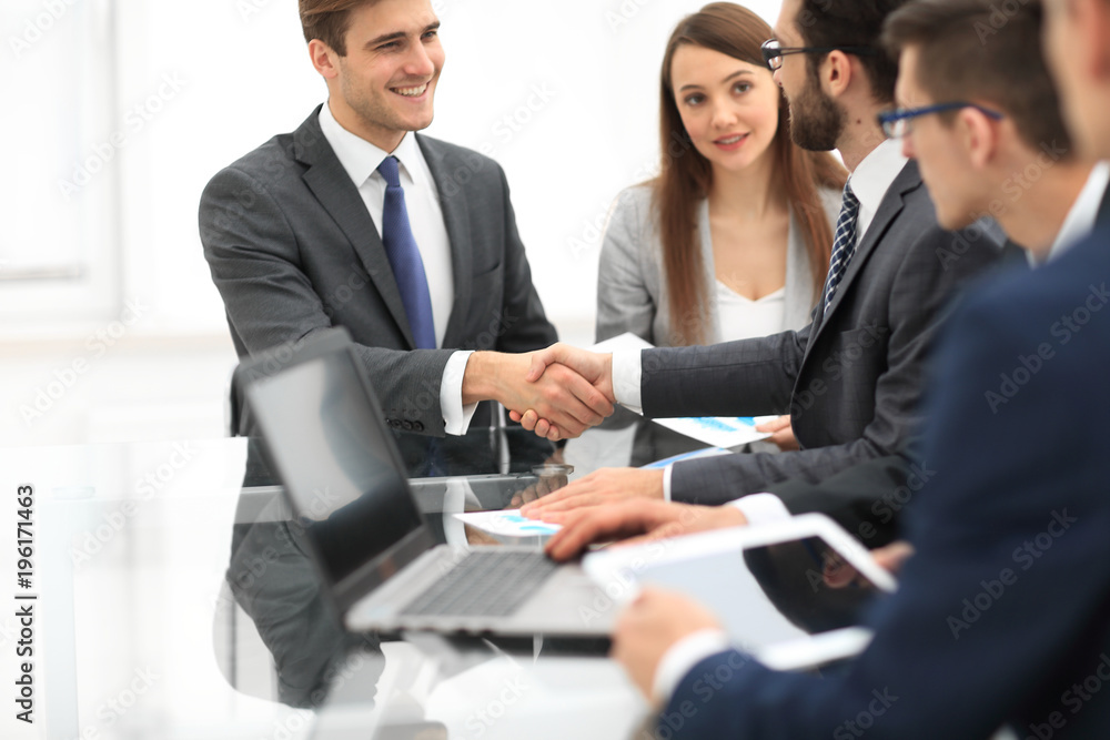 Business colleagues sitting at a table during a meeting with two Business colleagues sitting at a table during a meeting with two