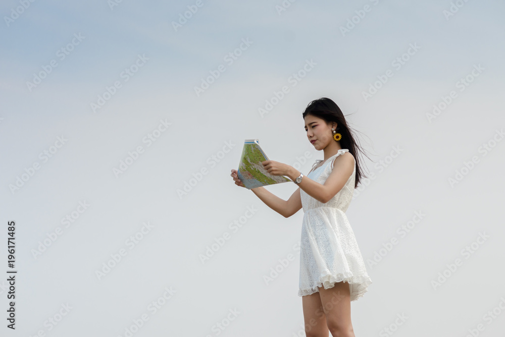 Happy tourist woman holding map on the beach. Happy tourist woman holding map on the beach.