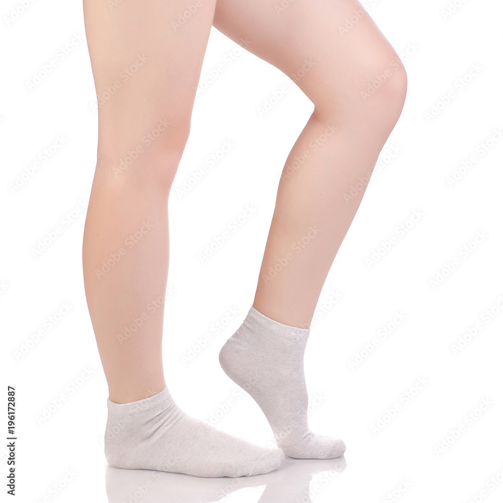 Female legs in white beige cotton socks