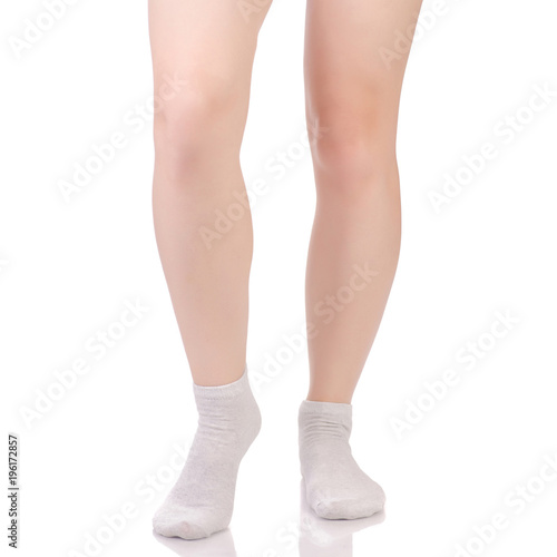 Female legs in white beige cotton socks © Kabardins photo