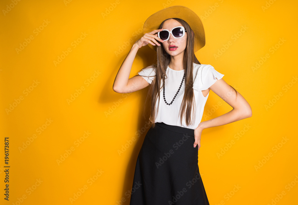 girl in sunglasses and hat posing on background girl in sunglasses and hat posing on background