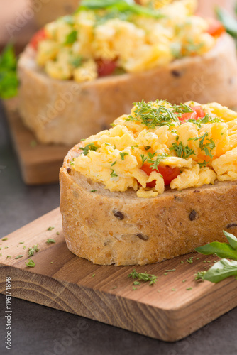 Tasty sandwich with egg and vegetables on old wood block background