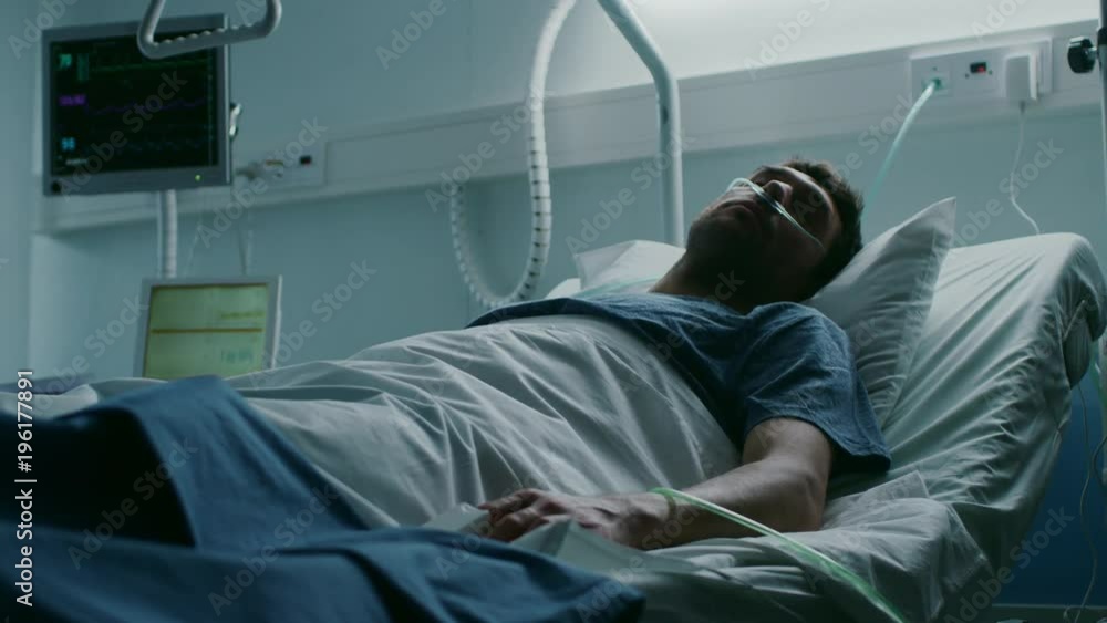 In the Hospital, Terminally Ill Man Suffers While Lying on the Bed. Young Man in Palliative Care Ward. Shot on RED EPIC-W 8K Helium Cinema Camera. In the Hospital, Terminally Ill Man Suffers While Lying on the Bed. Young Man in Palliative Care Ward. Shot on RED EPIC-W 8K Helium Cinema Camera.