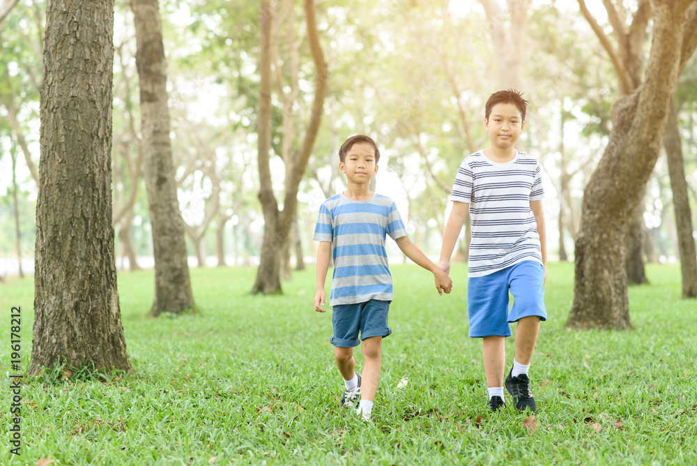 Two boy hold their hand and walk Two boy hold their hand and walk