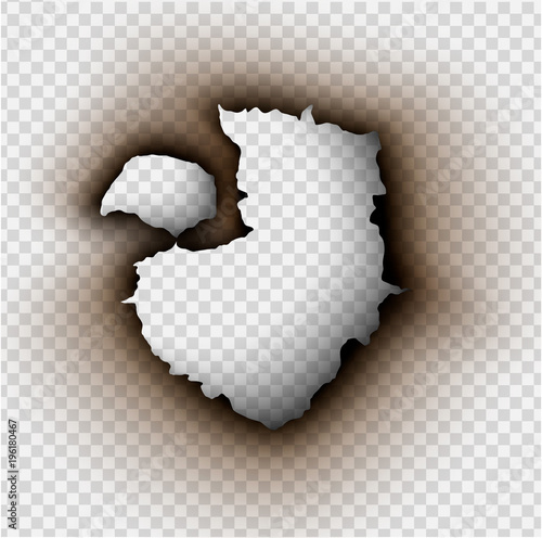 Hole torn in ripped paper with burnt and flame