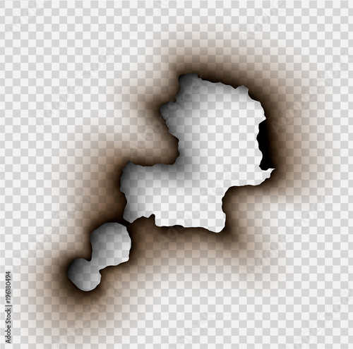 Hole torn in ripped paper with burnt and flame