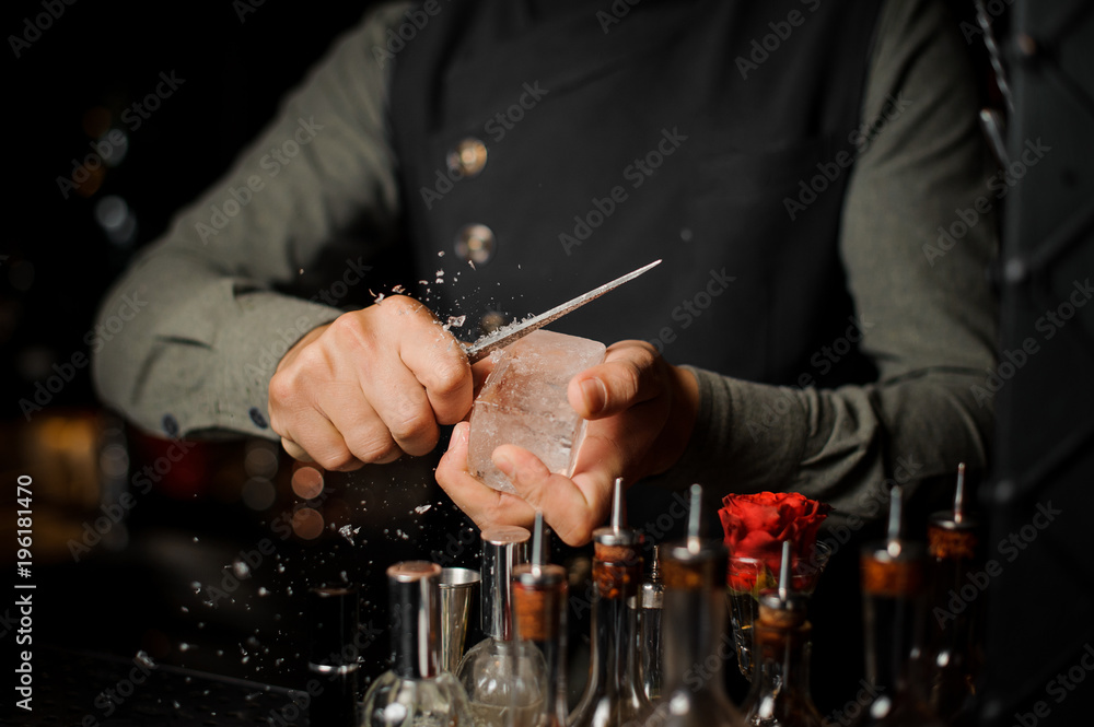 Barman preparing a large rectangular piece of ice