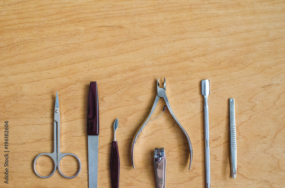 Tools of a manicure set on a wooden background Tools of a manicure set on a wooden background
