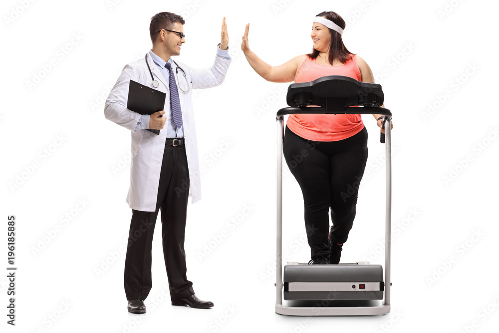 Doctor high-fiving an overweight woman exercising on a treadmill Doctor high-fiving an overweight woman exercising on a treadmill