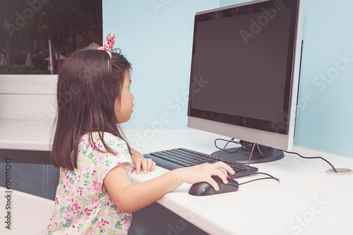 Girl playing with a computer