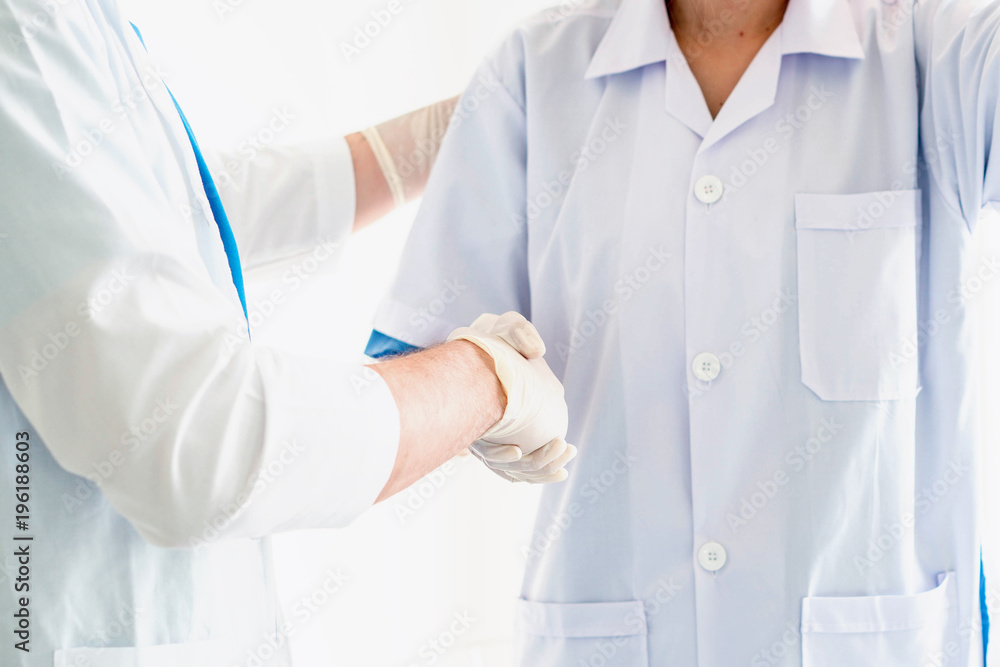 Two medical workers make handshake Two medical workers make handshake