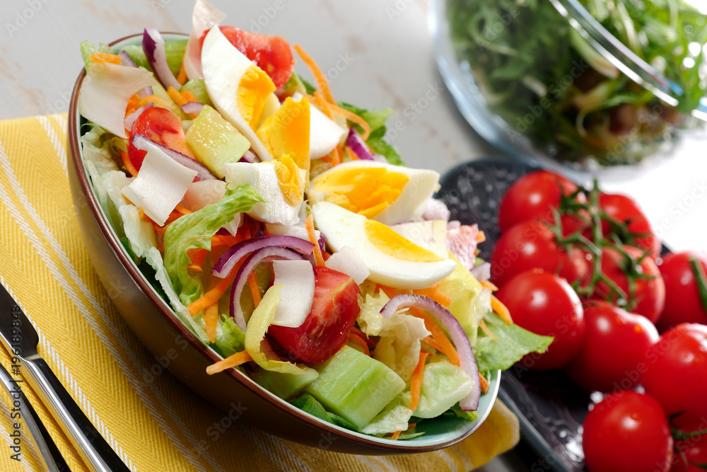 plate of vegetable salad on yellow towel
