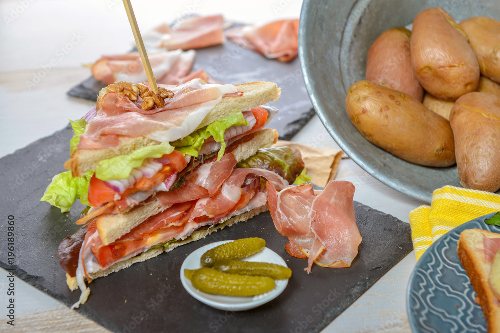 sandwiches with salad, tomatoes, ham and onions
